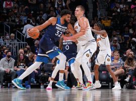 Karl-Anthony Towns from the Minnesota Timberwolves makes a move against Nikola Jokic from the Denver Nuggets. (Image: Getty)