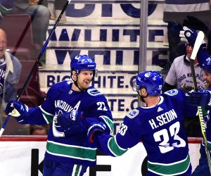 Daniel and Henrik Sedin in action for the Vancouver Canucks