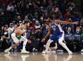 Jayson Tatum from the Boston Celtics makes a move on Joel Embiid from the Philadelphia 76ers. (Image: Getty)